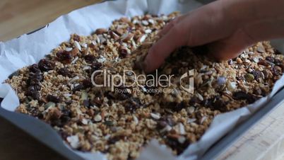 Hand of a woman touching granola