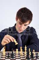 Young business man playing chess
