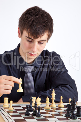 Young business man playing chess