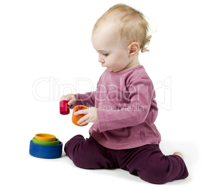 young child playing with colorful toy blocks