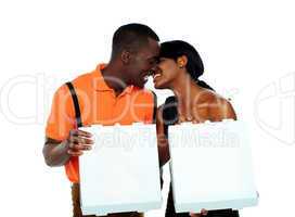 Black couple kissing and holding pizza boxes