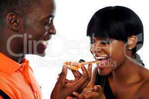 Beautiful african couple eating pizza
