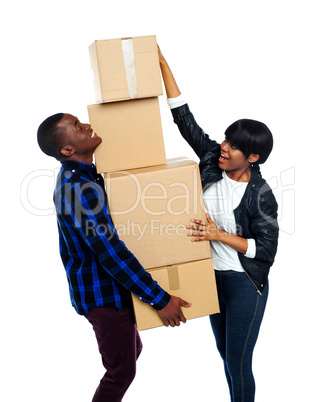 Teenage couple with cardboard boxes