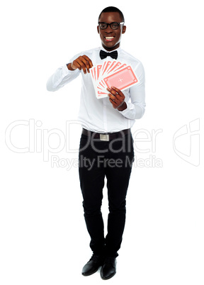 Portrait of a young man holding cards
