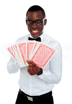 Young black man holding out deck of cards