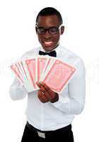 Young black man holding out deck of cards