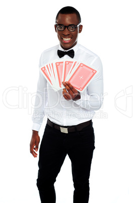 A man holding up a few playing cards