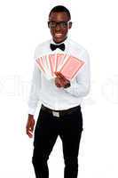 A man holding up a few playing cards