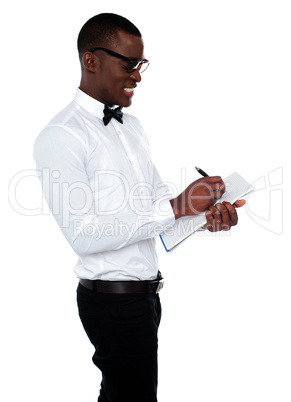 African employee writing on clipboard