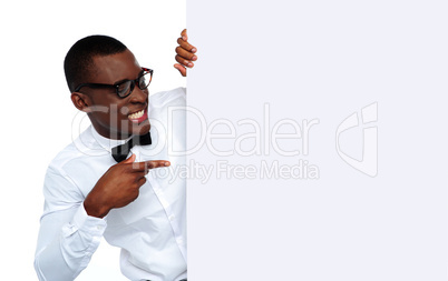 African young man pointing at blank billboard