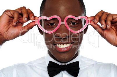 Smiling man wearing heart shaped eye-wear