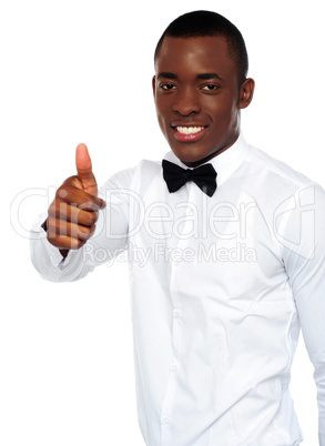 African boy in party-wear gesturing thumbs-up