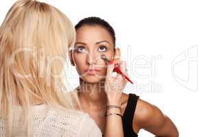 Makeup artist applying makeup to her model