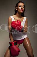 Seductive woman boxer glistening with sweat