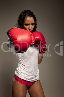 Athletic woman boxer throwing a punch