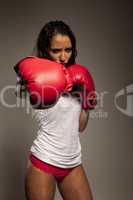 Athletic woman boxer throwing a punch