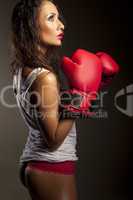 Sexy woman boxer pausing during training