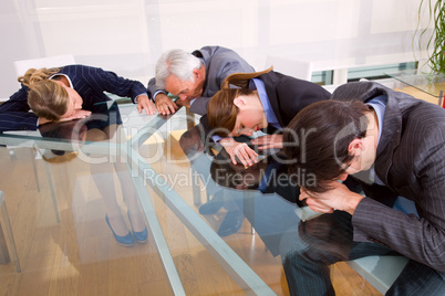 businessmen and businesswomen exhausted during a meeting