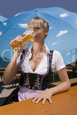 Junge Frau in Tracht im Biergarten