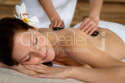 Hot stone massage woman enjoy spa treatment