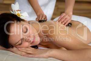 Hot stone massage woman enjoy spa treatment