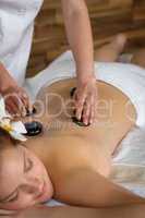 Lava stone massage woman at luxury spa