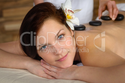 Woman enjoy hot lava stone massage spa