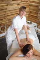 Luxury spa room masseur woman back massage
