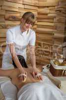 Back brush massage at luxury spa centre