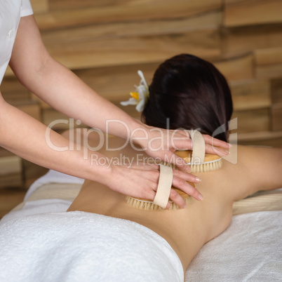 Back brush massage at luxury spa centre