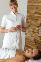 Woman and masseur at luxury spa room