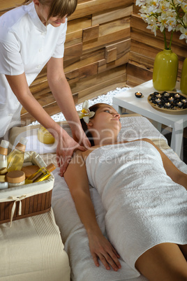 Woman shoulder massage at luxury spa centre