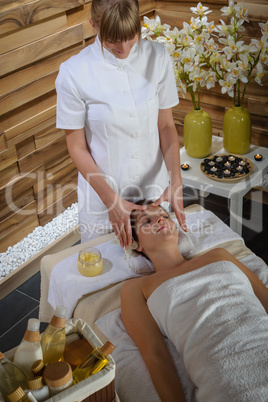 Woman head massage at luxury spa centre