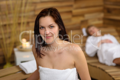 Woman at spa room wrapped in towel