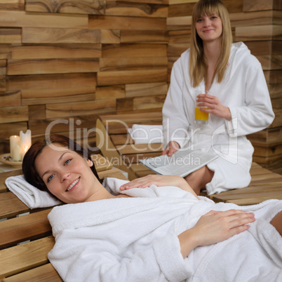 Smiling woman at spa lying down