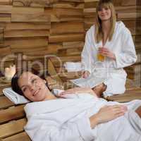 Smiling woman at spa lying down