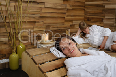 Happy woman at spa center lying down