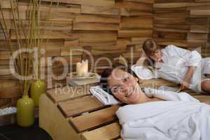 Happy woman at spa center lying down