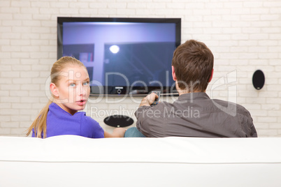man watching tv woman looking back