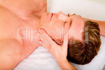 young man receives a face massage