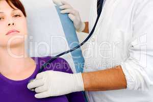 doctor visits a young caucasian woman with stethoscope