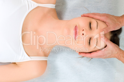 young caucasian woman lying down receiving head massage