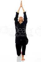 Young businesswoman doing yoga on white background studio