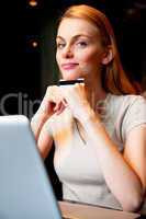 shopping online smiling young woman with laptop and credit card