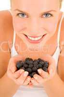 Woman with blueberries in hand