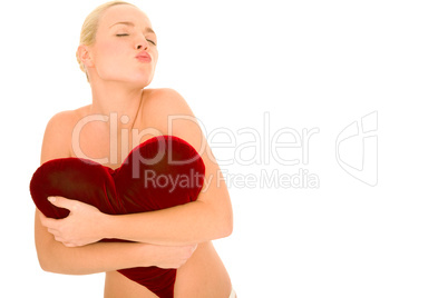 naked woman with heart-shaped pillow