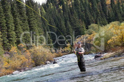 Fisherman fly fishing