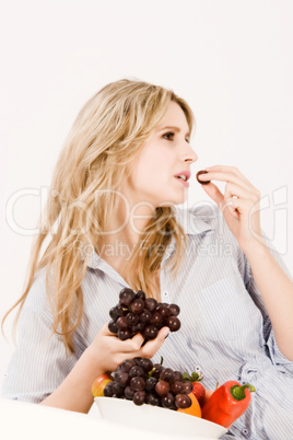 Schöne junge Frau beim Obst essen