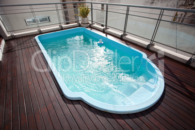 Blue swimming pool on the roof