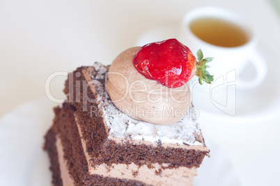 beautiful cake with strawberry and tea on a white background
